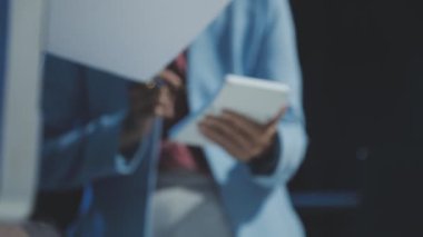 businesswoman holding document and writing in office