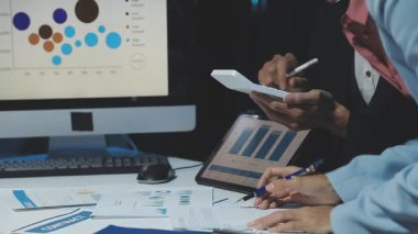 young businesswoman working in office with computer, business man using tablet computer and documents on desk