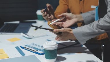 businessman writing on clipboard at meeting