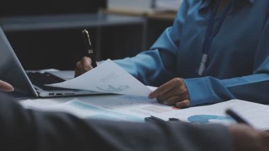 business team working with financial report and laptop