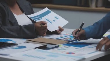 business woman analyzing financial data on laptop at desk.