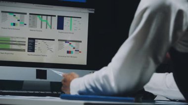 Modern Ofiste Gece Geç Saatler: İşadamı ve İş kadını Masaüstü Bilgisayarı Üzerinde Çalışıyor, Tartışıyor, Problem Çözümü Buluyor, Projeyi Bitiyor. Başarılı Sorumluluk Sahipleri Bürosu çalışanları