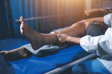 Rehabilitasyon terapisi, rehabilitasyon merkezlerinde çalışan profesyonel erkek fizyoterapistler, erkek hastaların bacak ve kas ağrılarını tedavi ederken,.