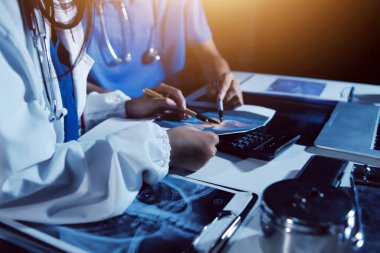 Doktorlar tedavi seçeneklerini tartışmak ve iş arkadaşlarıyla deneyimleri paylaşmak için hastanede toplanıyorlar.