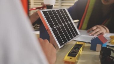 İki mimar planları analiz ediyor ve ofis ortamındaki bir inşaat projesi hakkında detaylı bir tartışmaya girişiyorlar.