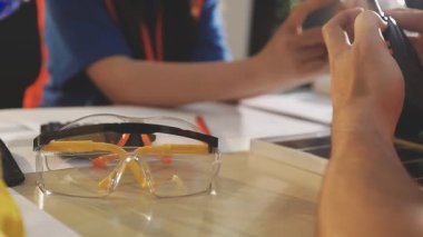 İki mimar planları analiz ediyor ve ofis ortamındaki bir inşaat projesi hakkında detaylı bir tartışmaya girişiyorlar.