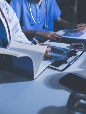 Doktorlar tedavi seçeneklerini tartışmak ve iş arkadaşlarıyla deneyimleri paylaşmak için hastanede toplanıyorlar..