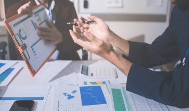 Muhasebe şirketi kârlı nakit akışı için finansman ve vergilendirme planlaması, ofiste çalışan denetçi ve muhasebeci ekibi, mali verileri ve muhasebe kayıtlarını hesap makinesiyle analiz eder