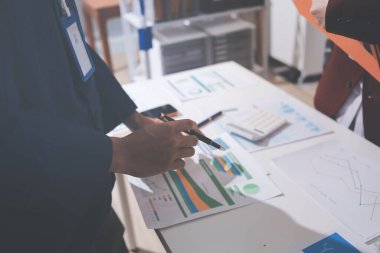 Muhasebe şirketi kârlı nakit akışı için finansman ve vergilendirme planlaması, ofiste çalışan denetçi ve muhasebeci ekibi, mali verileri ve muhasebe kayıtlarını hesap makinesiyle analiz eder