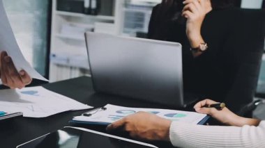 Ticari ekip tablet bilgisayardaki mali verileri tartışıyor ve analiz ediyor