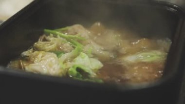 Masaüstü Shabu set konsepti. Bir tencere lezzetli sebze ve et yahnisi..