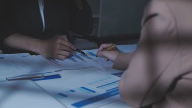 İki İşadamı İşyerinde Hesap Makinesini kullanarak Faturaları Hesaplıyor. İş ekibi toplantısı ve proje planı. İş adamları toplantı odasında tartışıyor.