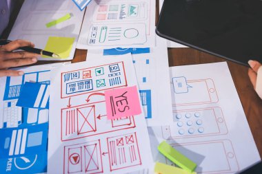 Mobil uygulama arayüzü kablo dizaynı hakkında modern ofisteki müşteri breif ve renk kodu ile fikir alışverişinde bulunan uu geliştirici ve ui tasarımcısını kapat. Yaratıcı dijital geliştirme ajansı.