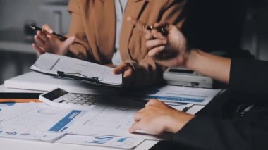 İki İşadamı İşyerinde Hesap Makinesini kullanarak Faturaları Hesaplıyor. İş ekibi toplantısı ve proje planı. İş adamları toplantı odasında tartışıyor..