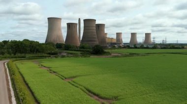 Büyük enerji santralinin havadan görünüşü, soğutma kuleleri ve kırsal yeşil arazideki baca yığınları. Güneşli yaz günü İngiltere