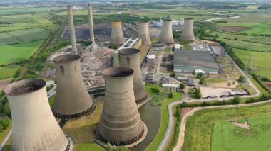 Büyük enerji santralinin havadan görünüşü, soğutma kuleleri ve kırsal yeşil arazideki baca yığınları. Güneşli yaz günü İngiltere