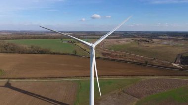 Büyük rüzgar türbini ve güneş paneli dizisinin hava aracı görüntüsü, yenilenebilir enerji santrali güneşli bahar sabahı Birleşik Krallık. Elektrik gücü..