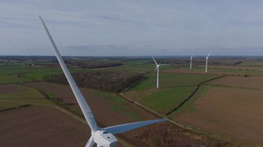 Büyük rüzgar türbini ve güneş paneli dizisinin hava aracı görüntüsü, yenilenebilir enerji santrali güneşli bahar sabahı Birleşik Krallık. Elektrik gücü..