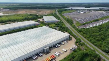 Aerial drone shot of distribution warehouses and data center logistics hub with truck cargo shipping import and export in United Kingdom, Europe