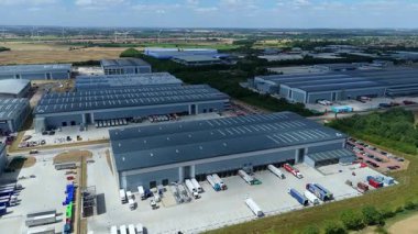 Biggleswade İngiltere 'deki kamyon kargo ithalat ve ihracatıyla birlikte dağıtım depolarının ve veri merkezi lojistik merkezinin insansız hava aracı görüntüsü.