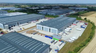 Biggleswade İngiltere 'deki kamyon kargo ithalat ve ihracatıyla birlikte dağıtım depolarının ve veri merkezi lojistik merkezinin insansız hava aracı görüntüsü.