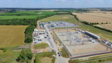 Gücü ulusal şebekeye aktarmak için elektrik santralinin, elektrik hatlarının, direklerin ve trafonun insansız hava aracı görüntüsü.