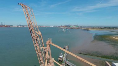 Büyük endüstriyel nakliye limanının hava aracı görüntüsü, ithalat için gemilere yüklenen kargo konteynırı yükü, İngiltere Felixstowe 'deki gantry vinçleri.