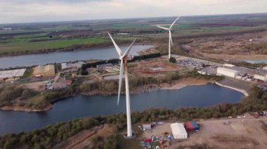 Endüstriyel arazi üzerindeki rüzgar türbinlerinin, depoların ve ticari faaliyet bölgesinin hava görüntüsü, Whittlesey, Peterborough, Birleşik Krallık 'ta sürdürülebilir yenilenebilir kaynaklar.