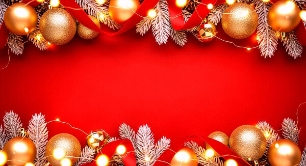 christmas background, new year greeting card with balls, golden christmas tree branches on red background. top view, flat lay