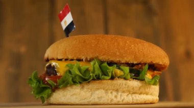 Üstünde küçük Mısır bayrağı olan lezzetli bir hamburger ve kürdan. Lezzetli hamburger dönüyor..