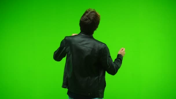 Мужчина танцует на зеленом экране в студии. Вид сзади. Ключ хромы — стоковое видео