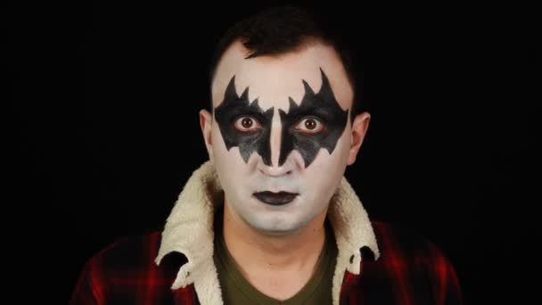 Man in demon makeup with crazy look on black background — Stock Video