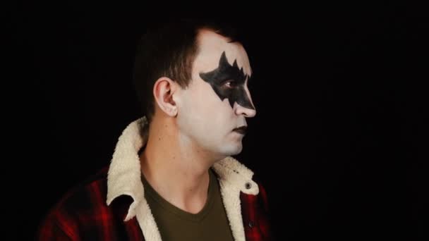 Male profile in scary demon makeup looks sideways — Stock Video