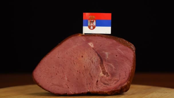 Person placing decorative Serbian flag toothpicks into piece of red meat. — Stock Video
