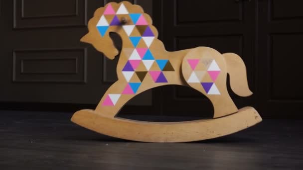 Big wooden rocking horse toy swings in a room — Stock Video