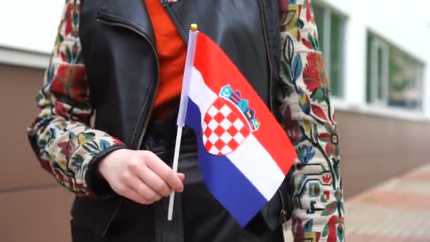Unrecognizable woman holding Croatian flag. Girl walking down street with national flag of Croatia — Stock Video