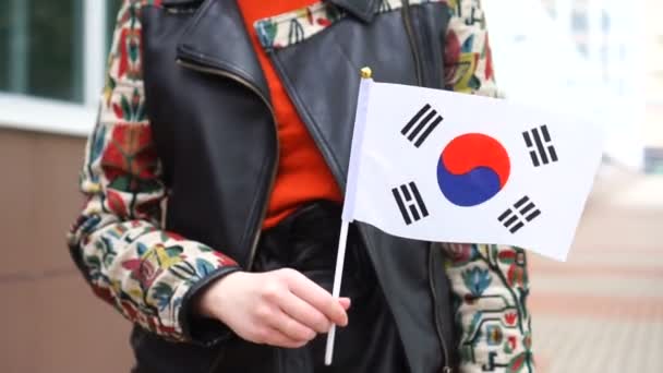 Neznámá žena držící korejskou vlajku. Dívka kráčející po ulici s národní vlajkou Jižní Koreje — Stock video