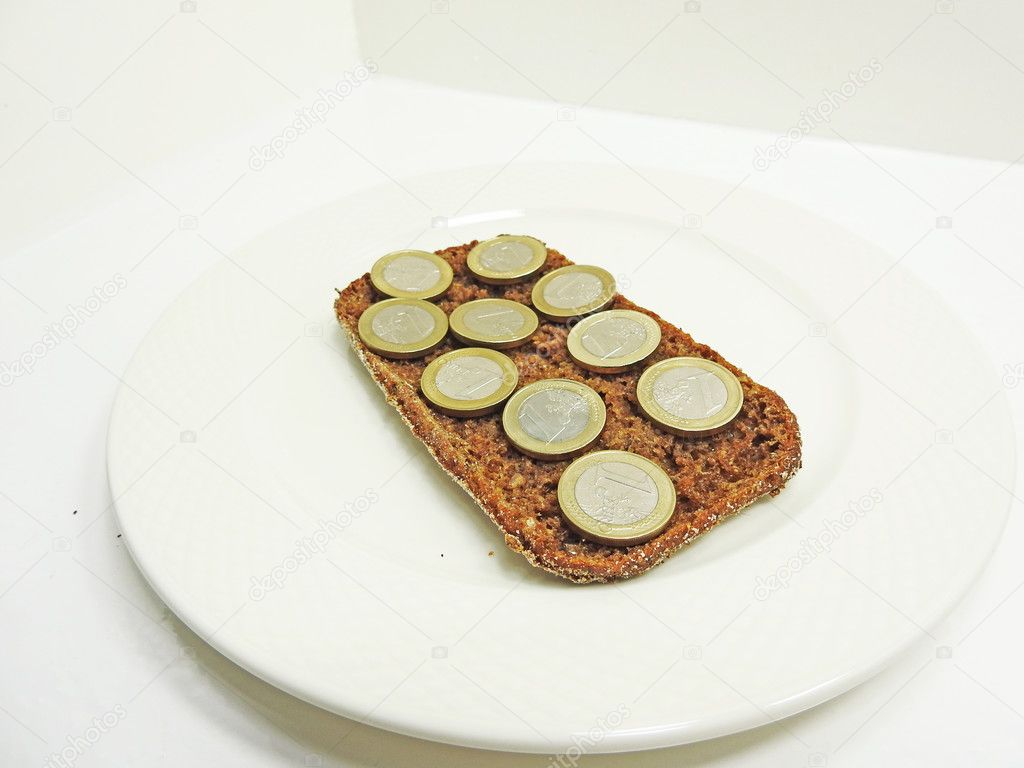 Euro cent coins on black bread.