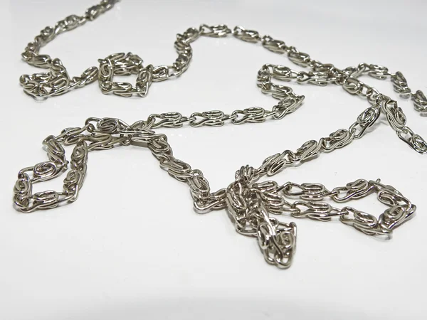 Small silver chain in abstraction. — Stock Photo, Image