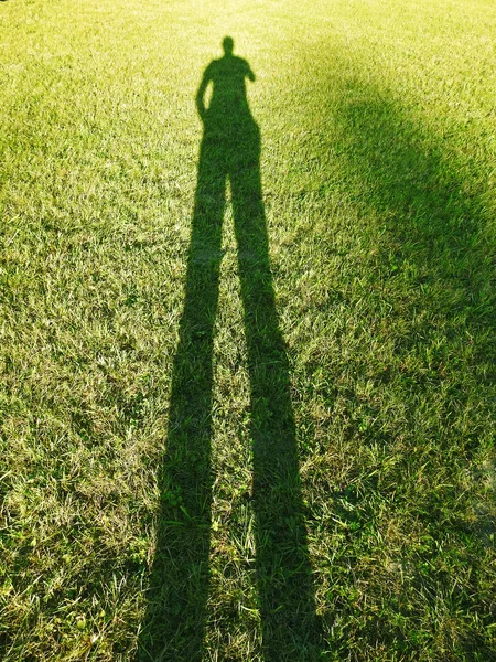 Long human shadow on summer evening.