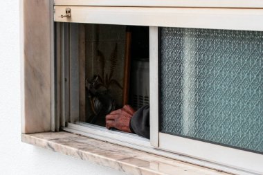 Kısmen Açık Pencereden Uzanan Tekerlekli Panjurlu El