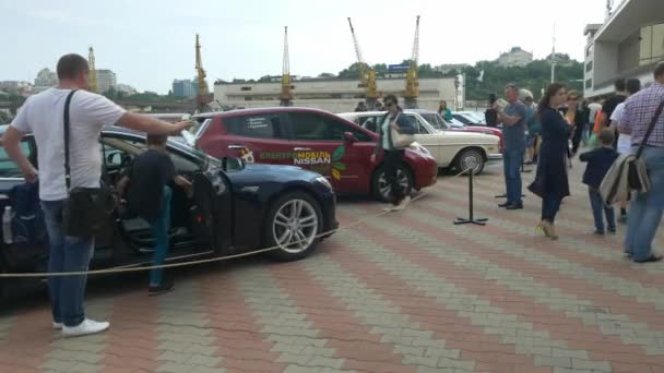 ODESSA, UKRAINE - JUNE 11 2016: Bike Cars and Rock n Roll retro festival. Kid sits inside Tesla electrocar. — Stock Video