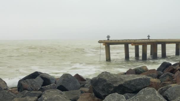 花崗岩の岩。ボラードと荒れた海で係船柱パイプ桟橋 — ストック動画