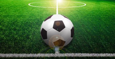 Futbol çim üzerinde top ve bir portakal güneş gibi ışık var.
