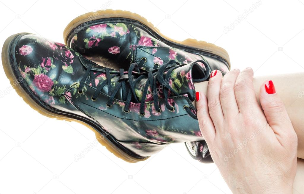 military style boots with flowers decoration on an hands with po