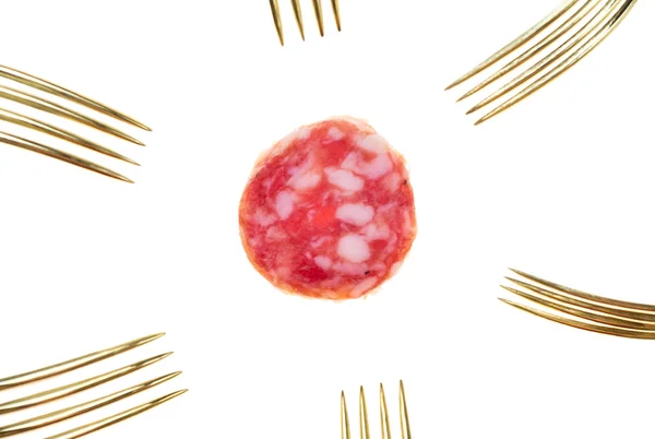 Slice of salami sausage and many vintage silver and golden forks — Stock Photo, Image