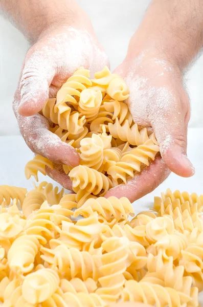 Male hands holding handmade rustic pasta