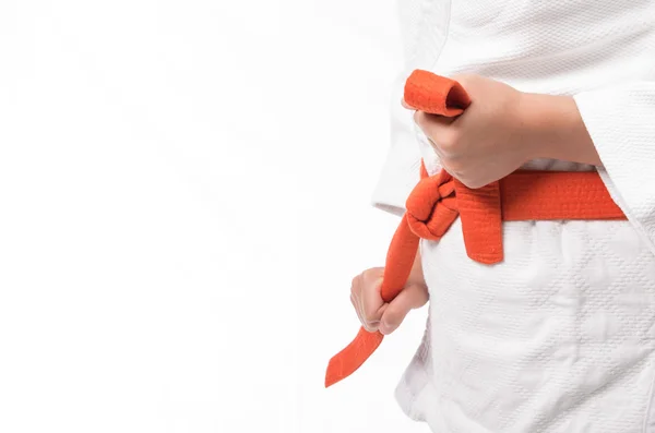 Close up of judo uniform, judo-gi, with orange belt isolated on white — Stock Photo, Image