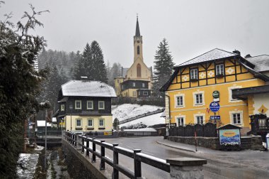 PREIN ON THE RAX, AUSTRIA - FEBRUARY 17, 2014: Snowfall in the Alpine village  Prein on the RAX. Lower Austria clipart