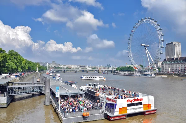 Londyn, Wielka Brytania-25 sierpnia 2013. Statki wycieczkowe po Tamizie na tle diabelskiego koła London Eye w Wielkiej Brytanii. — Zdjęcie stockowe